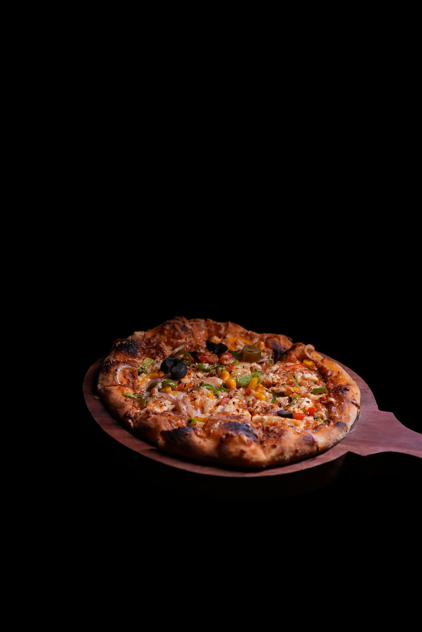 Veg Exotica pizza on wooden board